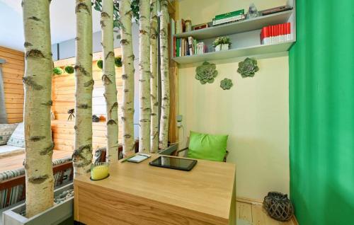 a room with a desk with trees on the wall at HIŽA BAKE ROZE in Gornja Konjšćina