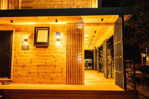 a building with a wooden wall with lights on it at Congo Bungalow in Ulcinj