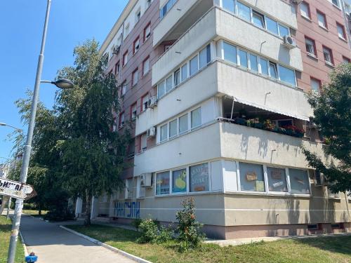 a tall building with windows on the side of it at Hill Apartment in Belgrade