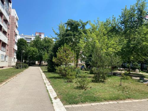 a park with trees on the side of a sidewalk at Hill Apartment in Belgrade