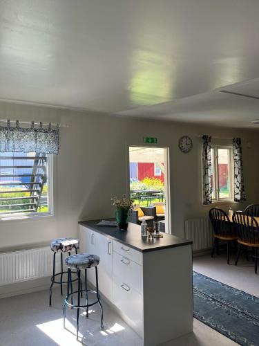 a kitchen with a counter and two stools at Trosa Vandrarhem in Trosa