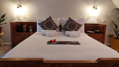 A bed or beds in a room at Old Jaffa House - Boutique Hotel