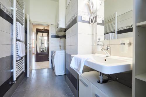 a white bathroom with a sink and a mirror at Wellness Penzion U Muzea in Liberec