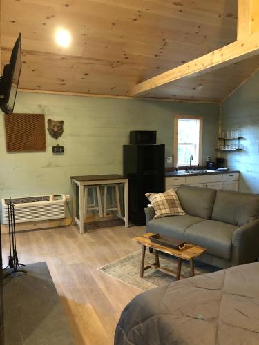 a living room with a couch and a table at Avenwood Cabins in Logan