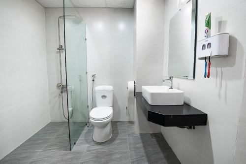 a bathroom with a toilet and a sink and a shower at Valentino Homestay in Hue