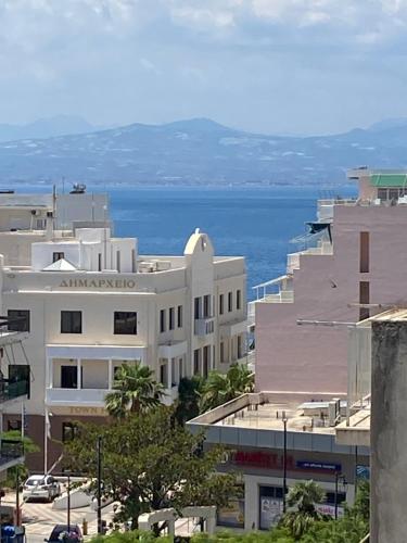 a group of buildings with the ocean in the background at Loutraki Vacation in Loutraki
