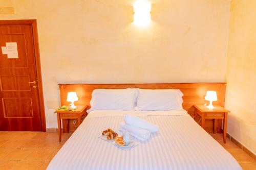 a bedroom with a bed with two donuts on it at Mediterraneo B&B in Pizzo
