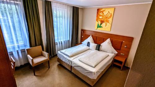 Postel nebo postele na pokoji v ubytování Hotel am Rathaus