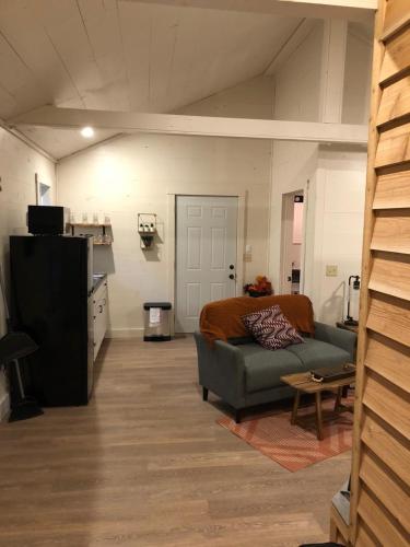 a living room with a couch and a bed at Avenwood Cabins in Logan