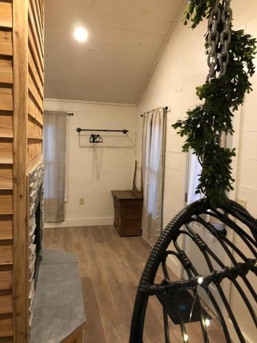 a room with a wooden floor and a room with a wheel at Avenwood Cabins in Logan