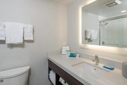 a bathroom with a sink and a toilet and a mirror at Holiday Inn Express - Sunnyvale - Silicon Valley by IHG in Sunnyvale