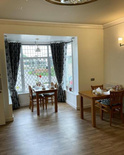 a dining room with a table and chairs and a window at The Loudor in Lincoln