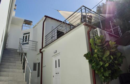 a white building with stairs and a stair case at "Spyros" 1-Room Apartment - Simple, cozy, close to the beach in Kato Daratso