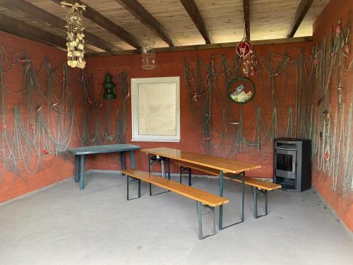 a room with two benches and a wall with artwork at Ferienwohnungen Stadtmitte - Fewo 1 in Sassnitz