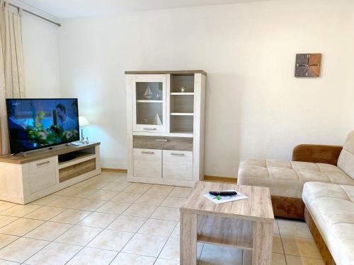 a living room with a couch and a tv at Ferienwohnungen Stadtmitte - Fewo 1 in Sassnitz