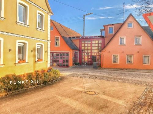a row of colorful buildings in a town at Wohnung 3 in Burghaslach