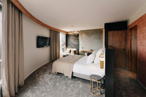 Ένα ή περισσότερα κρεβάτια σε δωμάτιο στο Golden Tulip Reims Bezannes