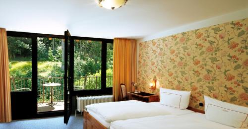 a hotel room with two beds and a window at Vintage Hotel Petrisberg in Trier