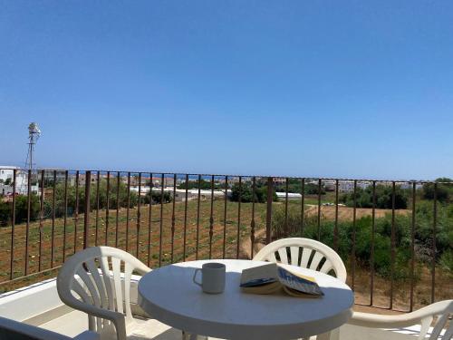 a table and chairs on a balcony with a view of the ocean at Kyklades Resort & Spa in Paralimni