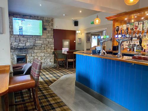 a bar in a restaurant with a fireplace at Vale of York in Thirsk