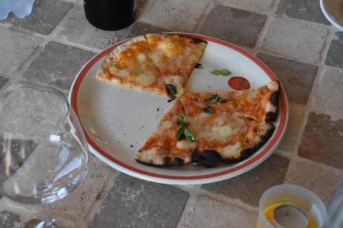 two slices of pizza on a plate on a table at Collerovere Country House in SantʼAngelo in Pontano