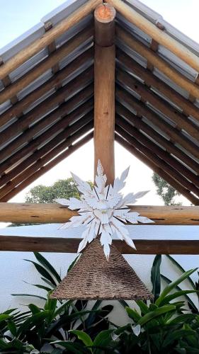 a white snowflake hanging from a wooden roof at Pousada Lírio Trancoso in Trancoso
