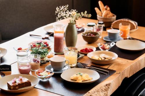a table with plates of food on top of it at ARX Guesthouse in Schladming