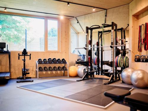 a gym with a lot of equipment in a room at ARX Guesthouse in Schladming