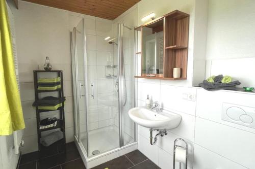 a bathroom with a sink and a shower at Ferienwohnungen Fricker in Oberstdorf