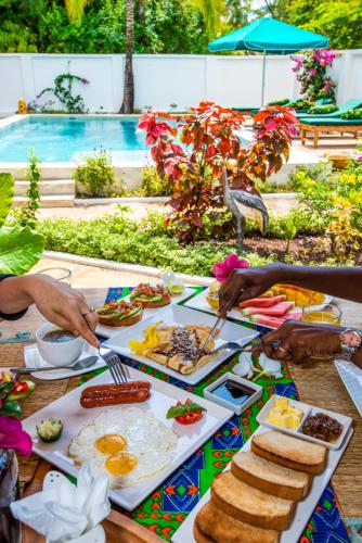 a group of people preparing food on a table at Daima Villas in Jambiani