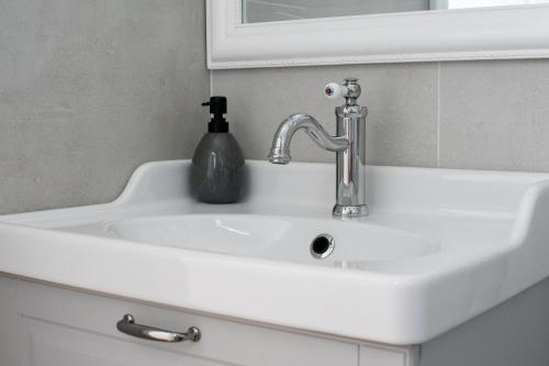 a white sink with a soap dispenser on it at Apartman Ana Borić in Podgora