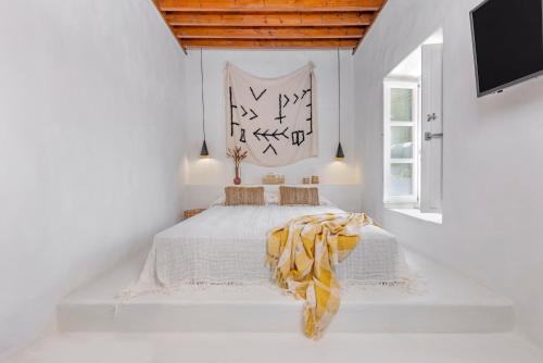 a white bedroom with a bed in a room at Peni sol Superior Studios Lindos in Líndos