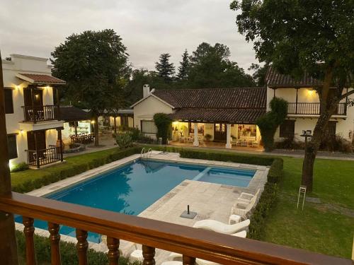 a swimming pool in the backyard of a house at Posada de los Poetas Hotel Boutique in San Lorenzo