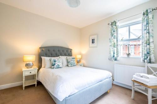 a bedroom with a bed and a window at Southbank Cottage in York