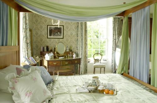 a bedroom with a bed with a table and a desk at Ballyduff House in Thomastown