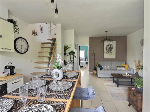 - une cuisine et un salon avec une table et des verres dans l'établissement L'Harmonieux Fontenay Sous Bois, à Fontenay-sous-Bois