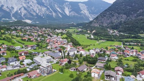 an aerial view of a town in a valley with mountains at Boutiquehotel - Michl in Sautens