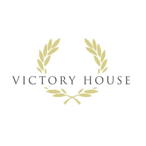 a logo for a victory house with leaves at Victory house in Lido di Ostia