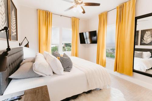 a bedroom with a bed with pillows and a tv at 230 9th Avenue in Ouray