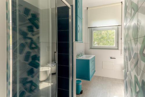 a bathroom with a blue cabinet and a sink at Un sogno sul lago Home Relax in Stresa