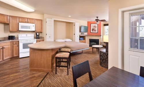 a kitchen with a table, chairs and a refrigerator at WorldMark Big Bear Lake in Big Bear Lake