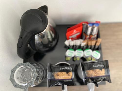 a kitchen counter top with a black blow dryer and spices at Crows Hotel in Lancaster
