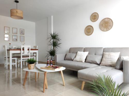 a living room with a couch and a table at Apartamento AREAL in Fisterra