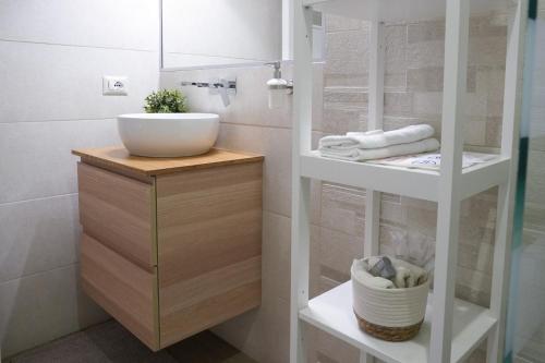 a bathroom with a sink and a counter with towels at Luxury Rooms Paoli 19 in Cagliari