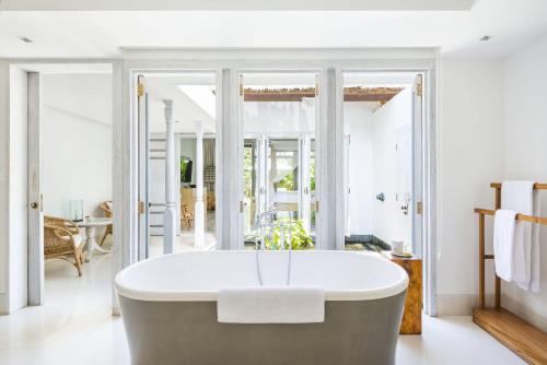 a bathtub in the middle of a living room at COMO Uma Ubud in Ubud