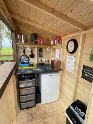 a small kitchen with a counter and a clock at Little Bunny Retreat in Bradmore