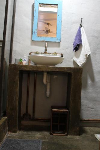 a bathroom with a sink and a mirror at The Hancock Inn in Klerksdorp