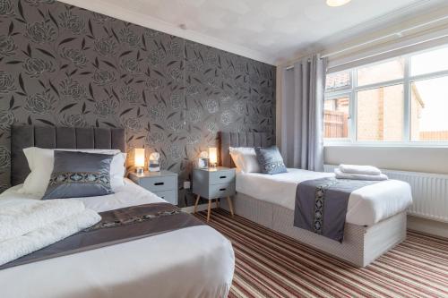 a bedroom with two beds and a wall mural at Cedar Drive, Holbeach - 1 to 4 - Self Catering in Holbeach