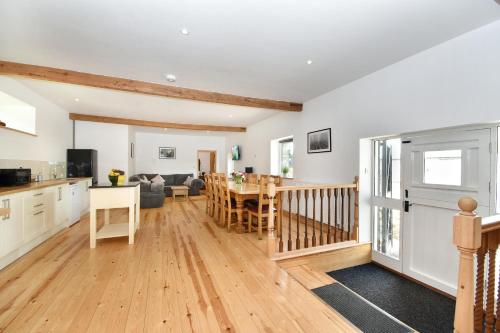 a kitchen and living room with a table and chairs at 5 Bed Barn Conversion - with private hot tub in Birchington