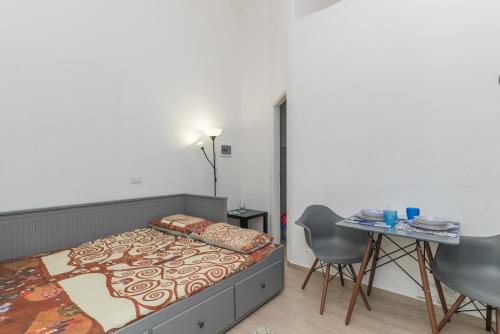 a bedroom with a bed and a table and chairs at Quercus Ilex B in Arzachena